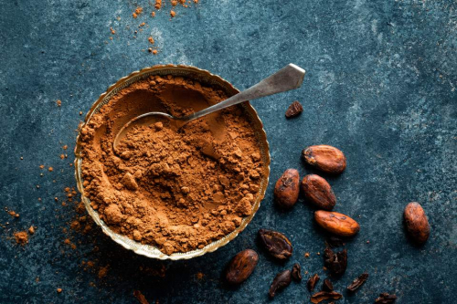 cocoa-powder-and-cacao-beans-on-dark-background--top-view-654544408-5ab44e6304d1cf00361f1b33.jpg